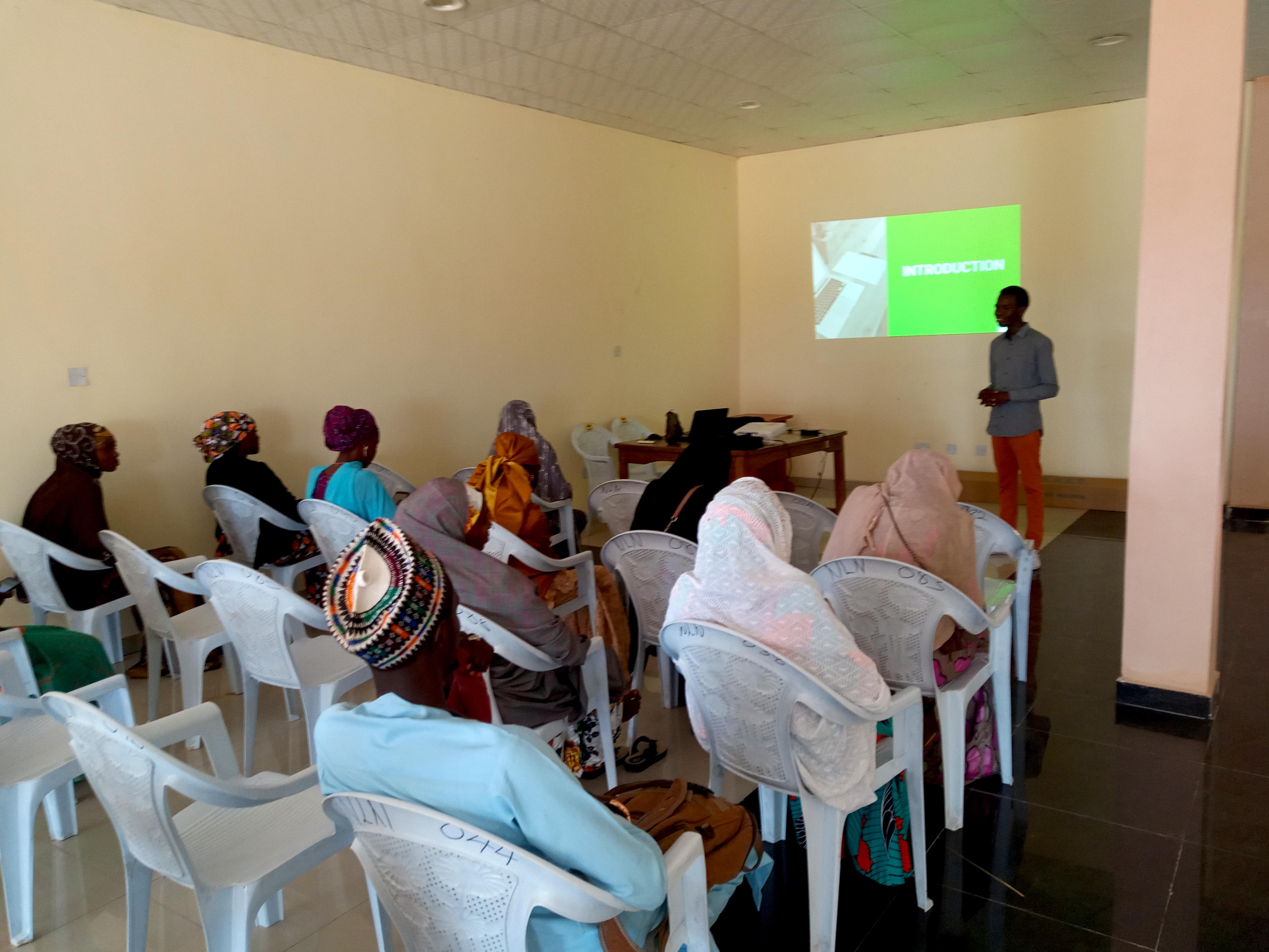 Workshop participants seated and listening to a facilitator in Gombe State
